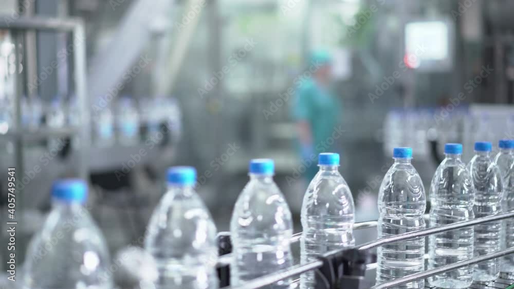 Plastic water bottles on conveyor and water bottling machine industry. Plastic water bottles on conveyor and water bottling machine industry.