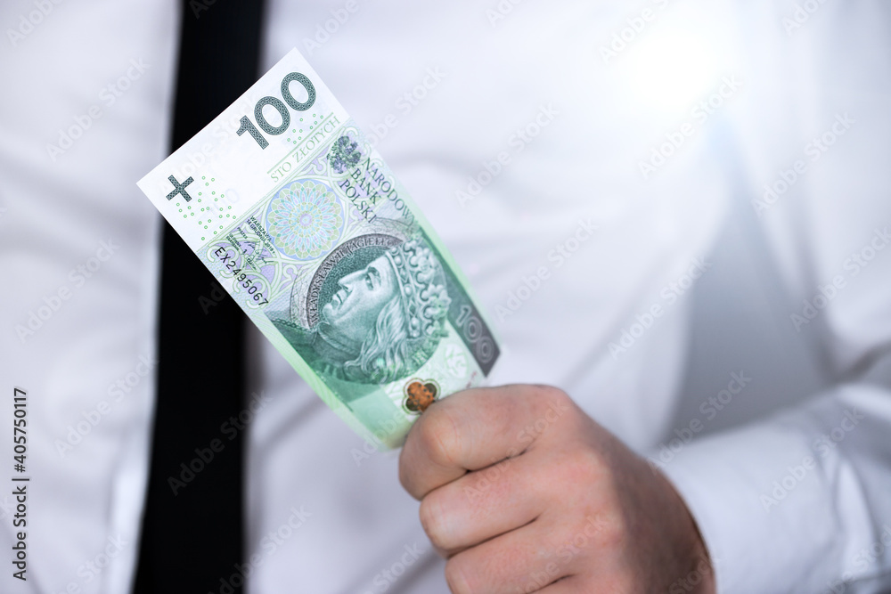 Polska waluta, sto złotych, 100 PLN. Banknot trzymany w ręce - obrazy, fototapety, plakaty 