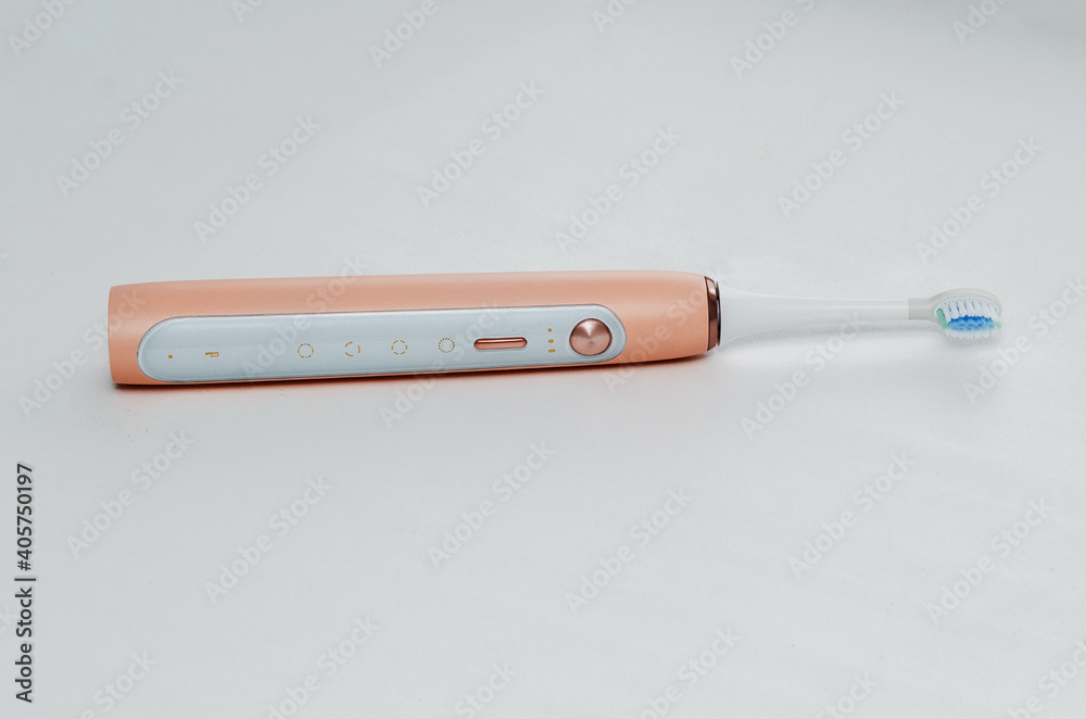 pink electric toothbrush for adults, over white background. Daily oral care. pink electric toothbrush for adults, over white background. Daily oral care.