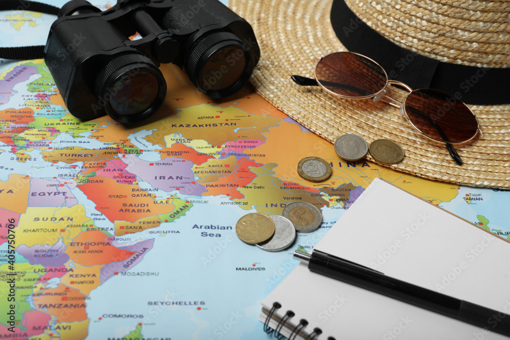 Different travel accessories on world map. Planning summer vacation trip Different travel accessories on world map. Planning summer vacation trip
