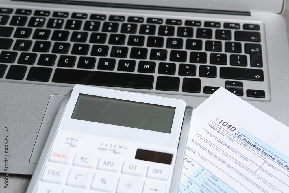 Calculator, document and laptop on table, closeup. Tax accounting Calculator, document and laptop on table, closeup. Tax accounting