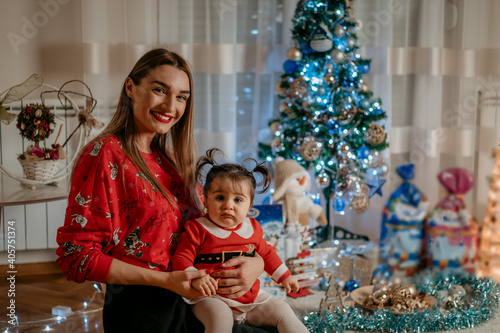 Beautiful young mother and with little baby girl child at home christmas holidays vibes and lifestyle