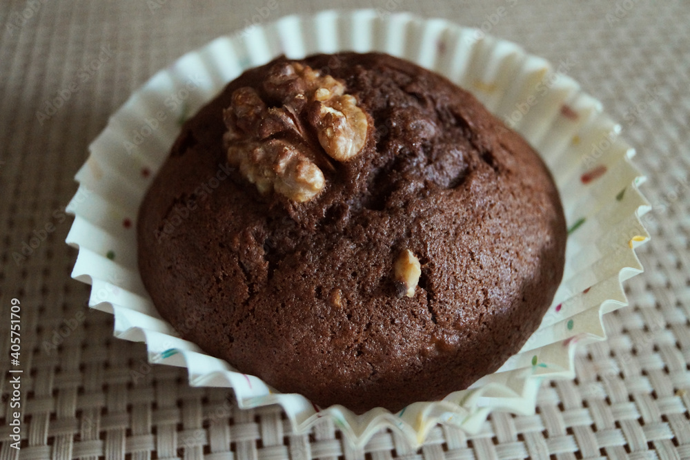 baking chocolate cupcake with walnut on the table horizontal macro photo baking chocolate cupcake with walnut on the table horizontal macro photo