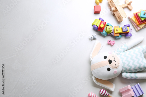 Different toys on light background, flat lay. Space for text