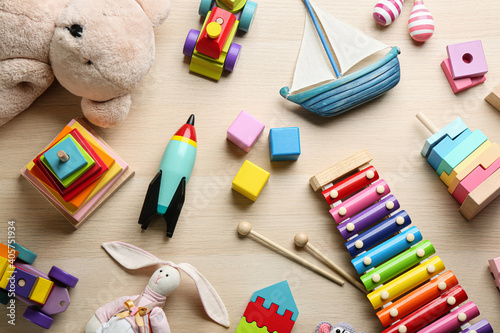 Canvas Print Different toys on wooden background, flat lay