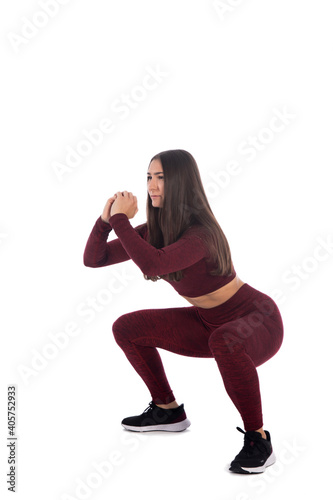 woman doing fitness exercise, isolated, Full length portrait of beautiful young woman doing stretching exercise isolated