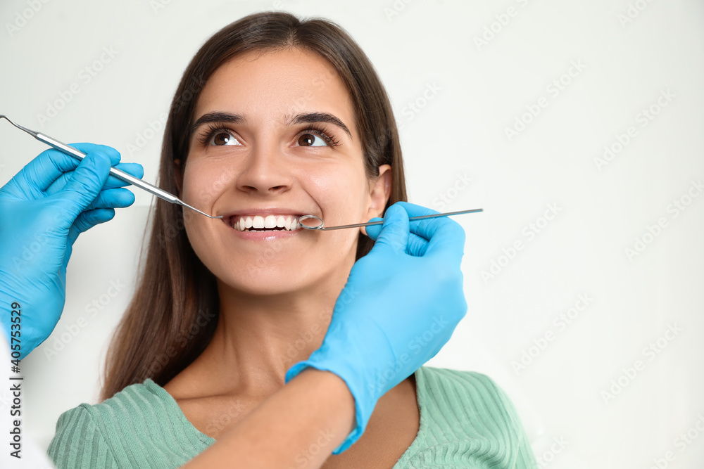 Dentist examining patient's teeth in modern clinic. Cosmetic dentistry Dentist examining patient's teeth in modern clinic. Cosmetic dentistry
