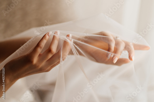 Photography hands of the bride under the veil. Tenderness.