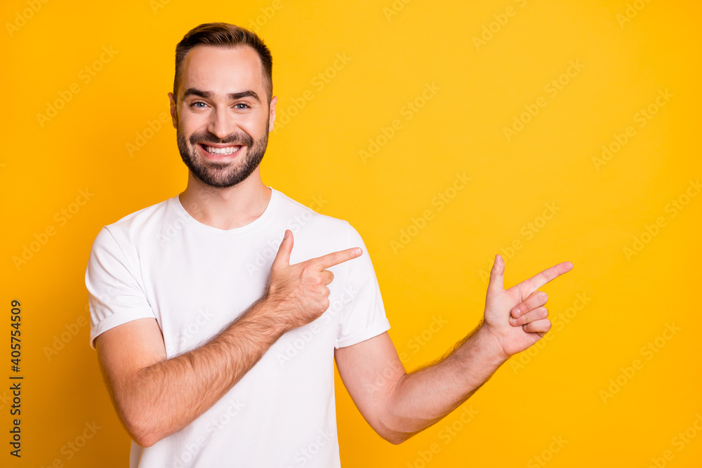 Portrait of attractive cheerful bearded guy showing copy space ad way isolated over bright yellow color background Portrait of attractive cheerful bearded guy showing copy space ad way isolated over bright yellow color background