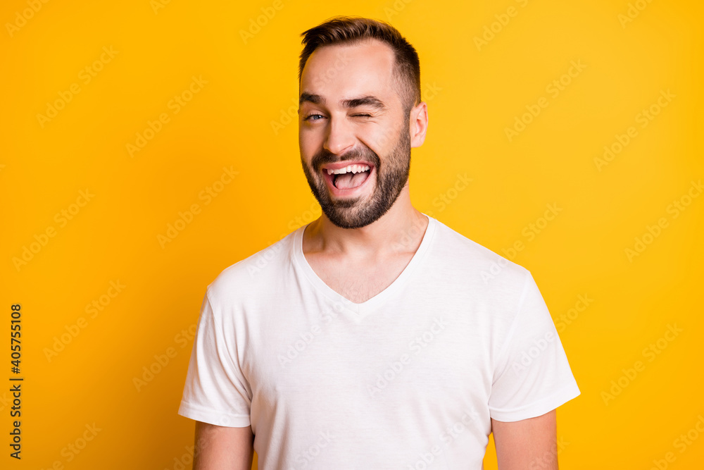 Portrait of cool guy blink wear white t-shirt isolated on vibrant yellow color background Portrait of cool guy blink wear white t-shirt isolated on vibrant yellow color background