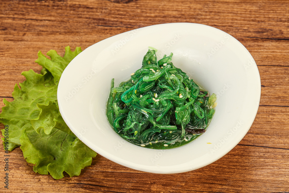 Green Chuka Seaweed Salad Isolated on White Background Top View. Wakame Sea Kelp Salat Green Chuka Seaweed Salad Isolated on White Background Top View. Wakame Sea Kelp Salat