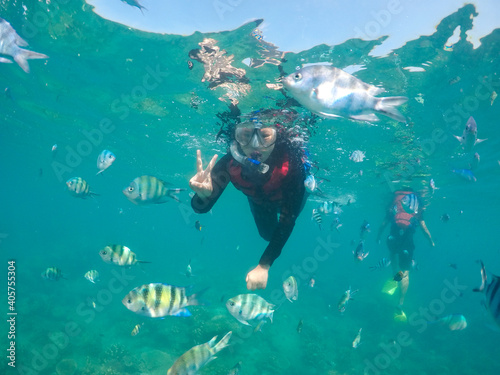 woman snorkeling with fish. Underwater moment