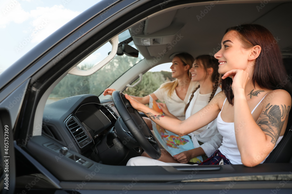 Happy friends together in car on road trip