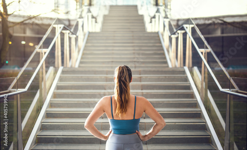 Woman in sportswear preparing for stair run.