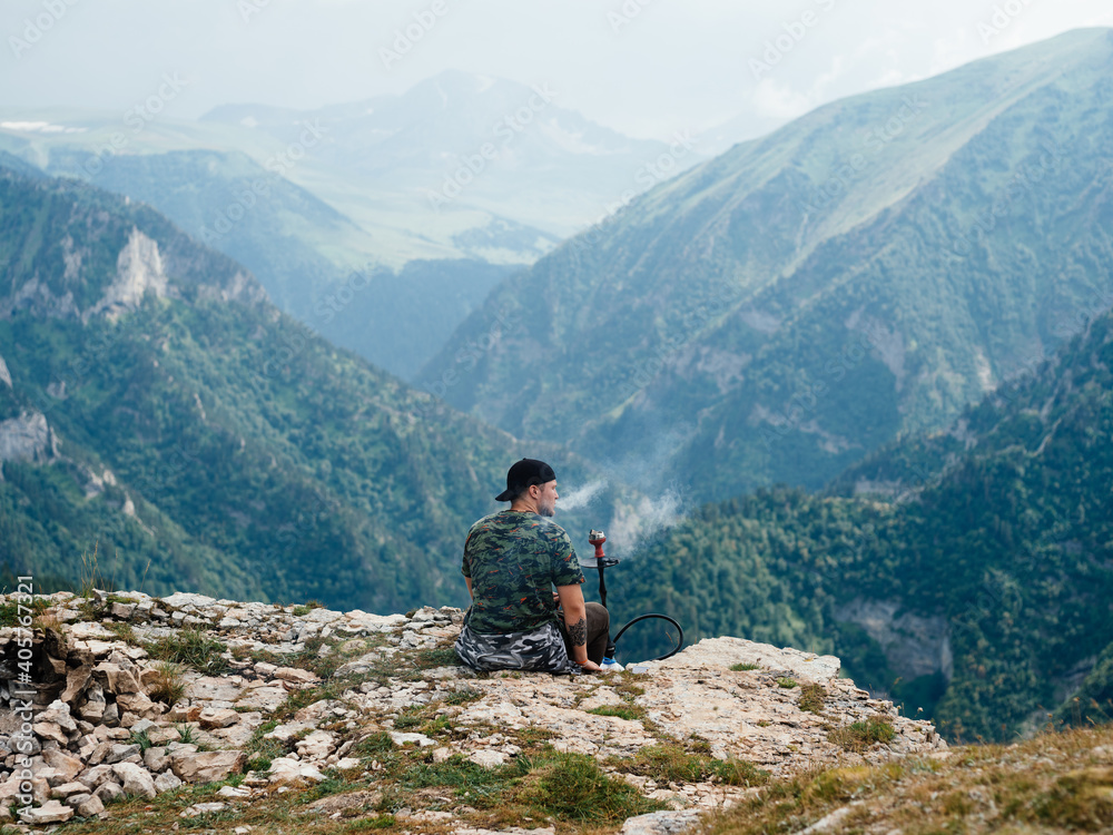 Man relax in the mountains on nature beautiful landscape fresh air fog sunlight