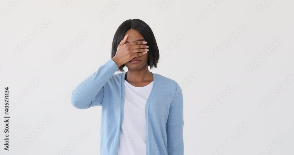 Woman covering her eyes on looking at something unpleasant Woman covering her eyes on looking at something unpleasant