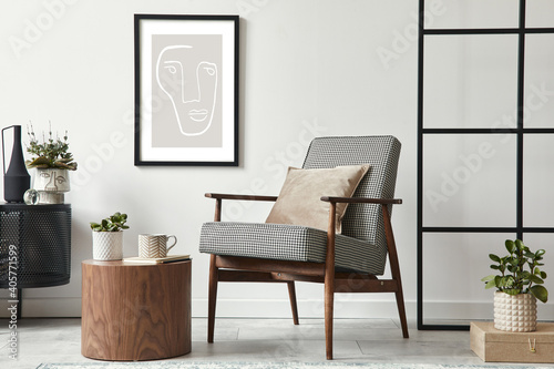 Stylish scandinavian composition of living room with design armchair  black mock up poster frame  commode  wooden stool  book  decoration  loft wall and personal accessories in modern home decor.