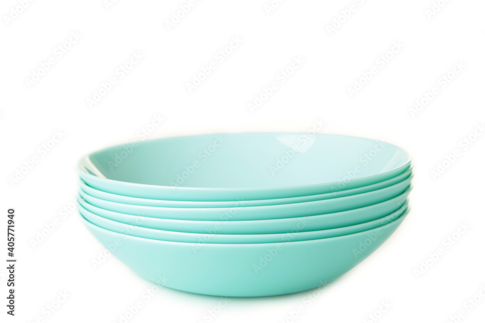 Set of stacked mint ceramic soup plates isolated on white background. Set of stacked mint ceramic soup plates isolated on white background.