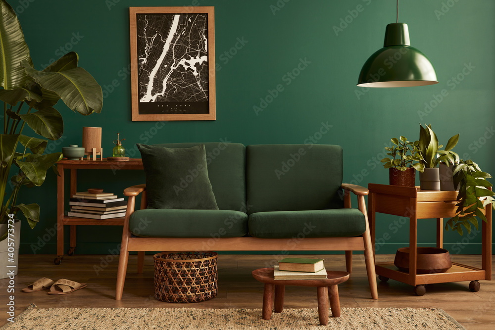 Stylish living room in house with modern retro interior design, velvet  sofa, carpet on floor, brown wooden furniture, plants, poster mock up map,  book, lamp and perosnal accessories in home decor. foto