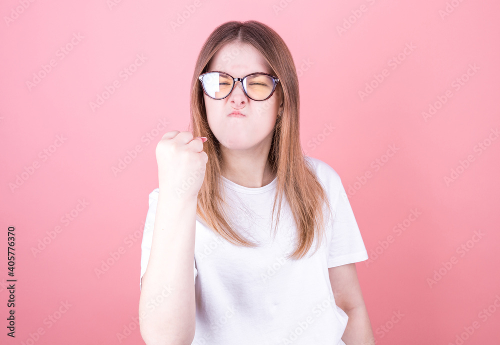 Beautiful woman in glasses with angry or frustrated threatening expression Beautiful woman in glasses with angry or frustrated threatening expression