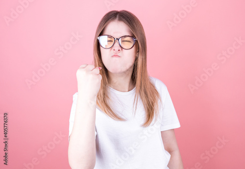 Beautiful woman in glasses with angry or frustrated threatening expression