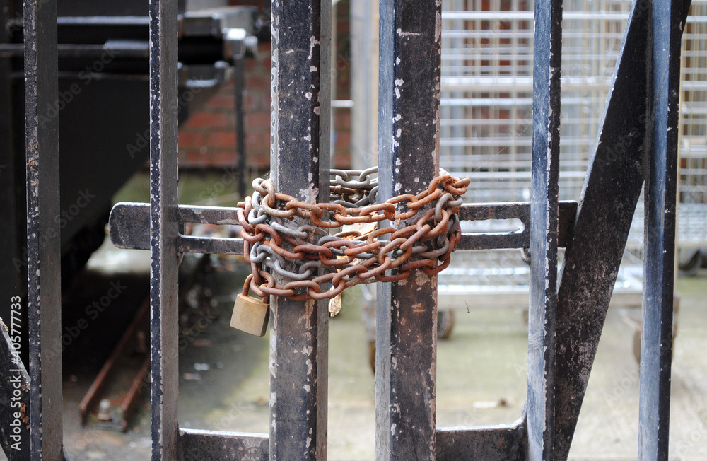 Close Up of Rusty Chain and Padlock on  Metal Gate 