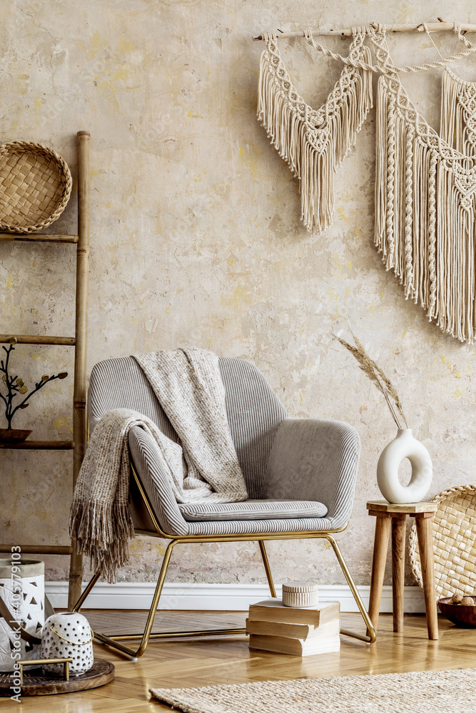 Stylish oriental living room with design armchair, beautiful macrame, wooden ladder, plant, decoration, carpet, coffee table, book and elegant personal accessories in wabi sabi concept. - obrazy, fototapety, plakaty 
