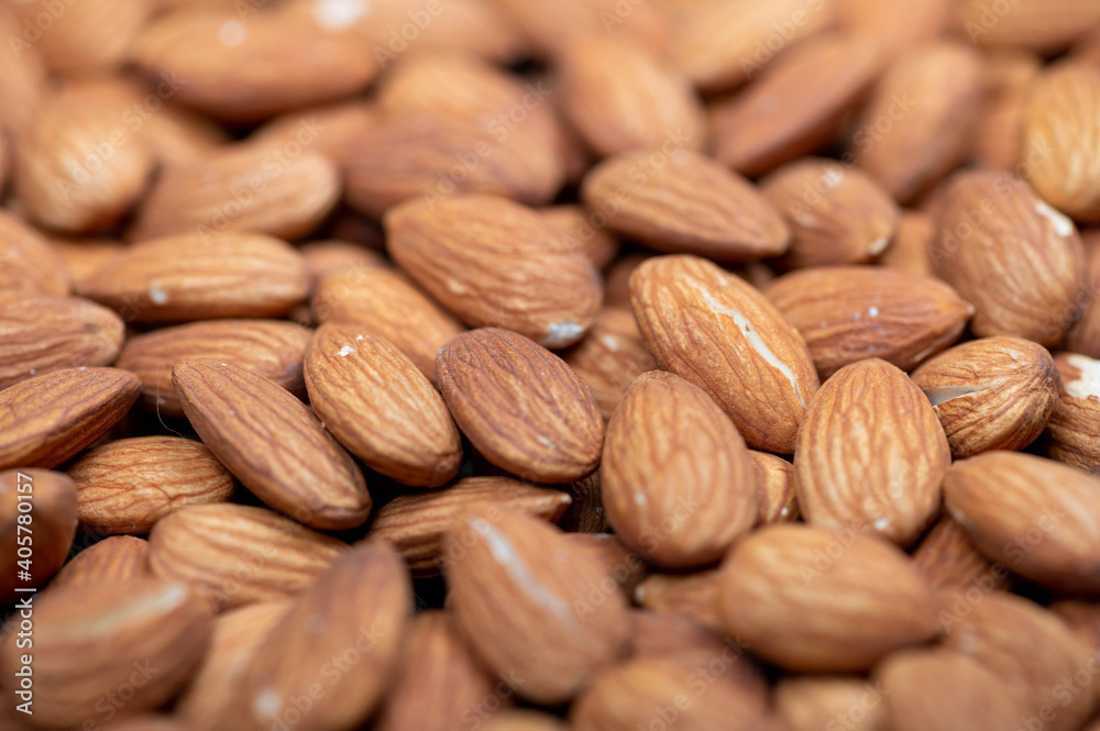 Almonds scattered on the table. Close-up, selective focus. Almonds scattered on the table. Close-up, selective focus.