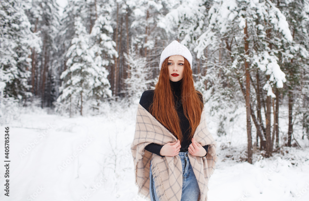 A young girl with long bright red hair on a winter background.A red-haired woman in a white cap. A young girl with long bright red hair on a winter background.A red-haired woman in a white cap.