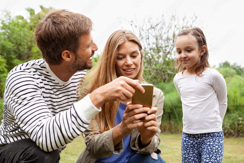 Happy family using smartphone Happy family using smartphone