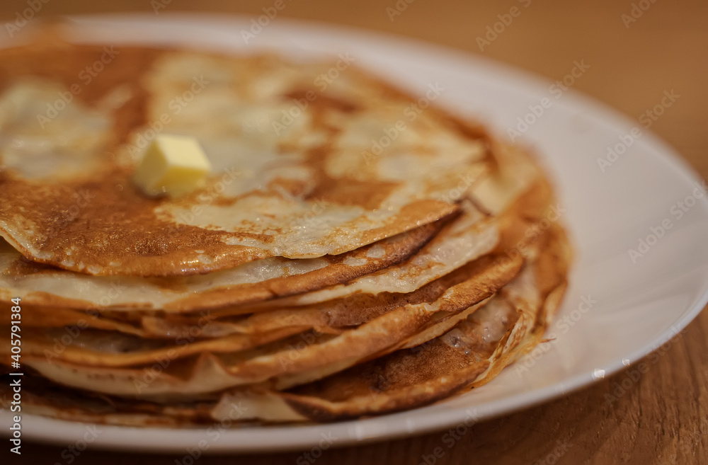 Lots of hot pancakes on the plate.