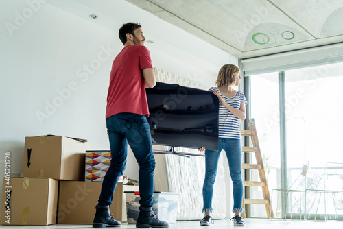 Young couple setting up in their new home photo