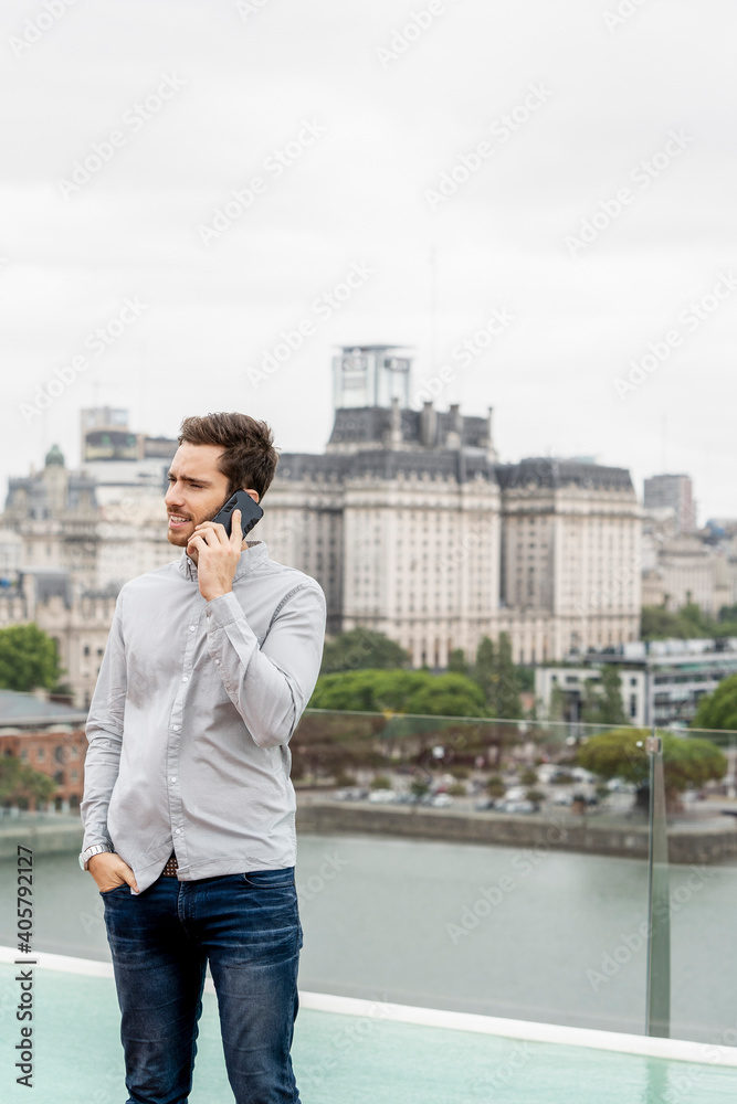 Young man talking on smartphone Young man talking on smartphone