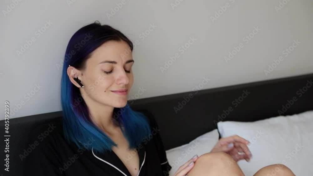 Young adult hipster women with wireless headphones in bedroom enjoy music Young adult hipster women with wireless headphones in bedroom enjoy music