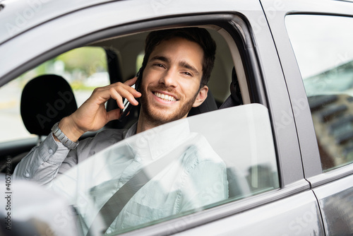Young man sitting in car