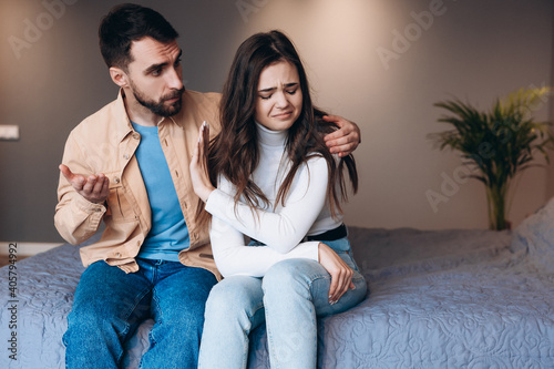 Relationship difficulties, conflict and people concept - unhappy couple having argument at home.