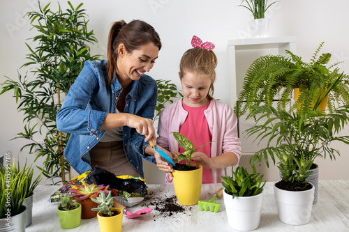 Mother and her daughter having some planting fun in their home