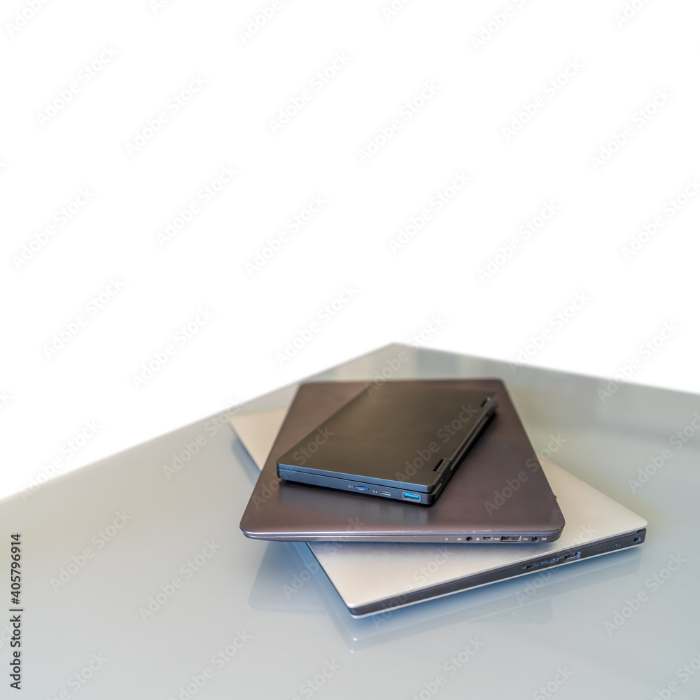 Laptops over glass table and white background for text space Laptops over glass table and white background for text space