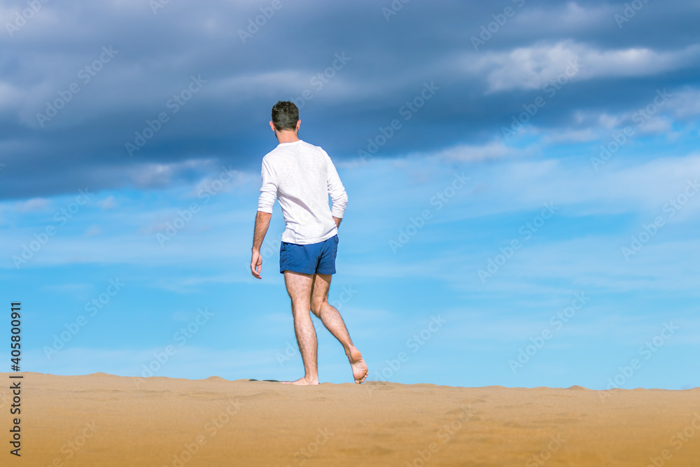 Young man walking on the dunes in Gran Canaria in December 2020 during Covid
