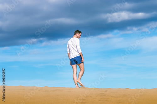 Young man walking on the dunes in Gran Canaria in December 2020 during Covid