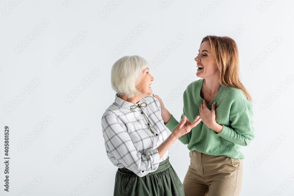 generation of happy women laughing while looking at each other isolated on white generation of happy women laughing while looking at each other isolated on white