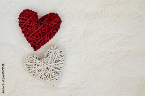 Two wicker heart decor on a light background with place for text.