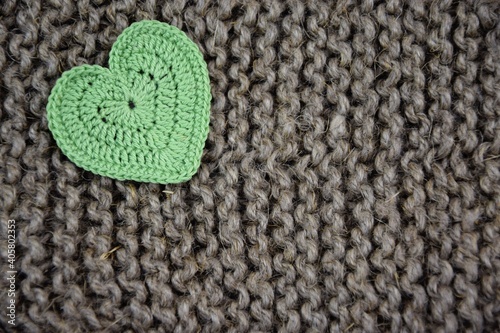 Natural jute wahsclothes and green crochet heart for background or texture, zero waste home, love being eco-friendly