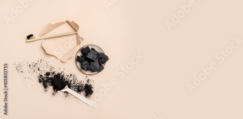 Quadro su tela Natural toothpaste activated charcoal in glass jar and bamboo toothbrush on beige color background
