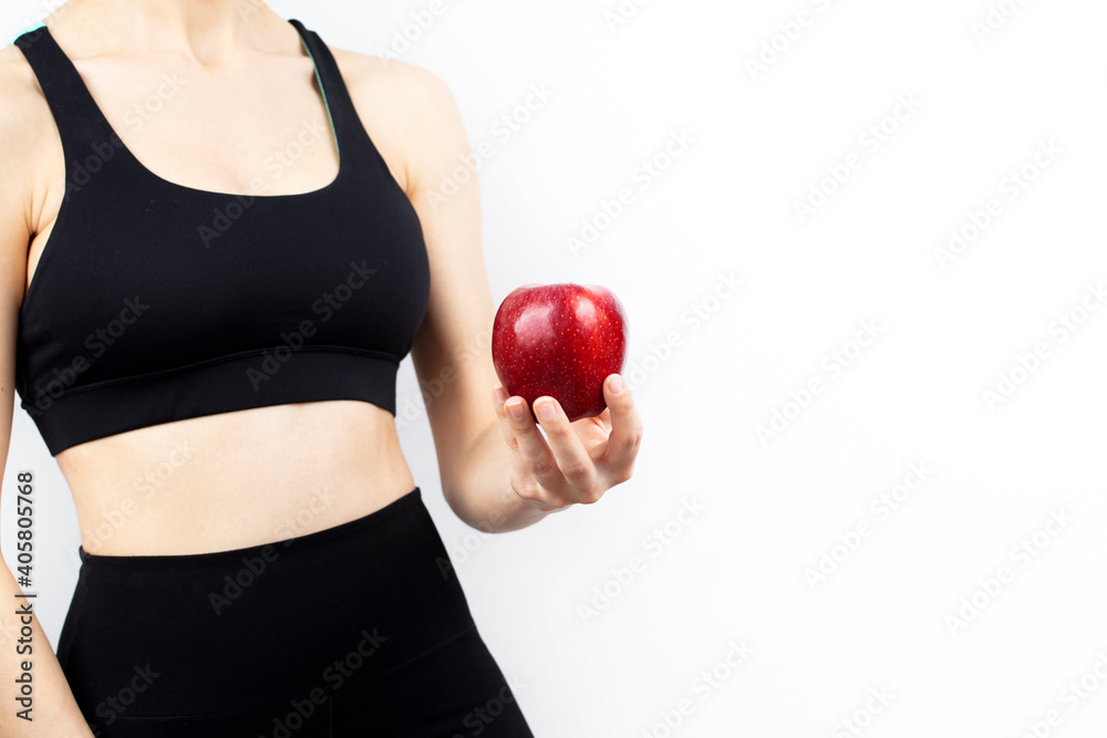 Apple in woman fitness hand. Healthy food and fitness concept.
Apple in woman fitness hand. Healthy food and fitness concept.