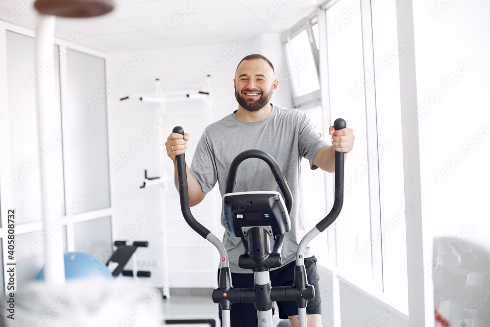 A man is doing the exercises. He has a training. The patient uses a spin bike. A man is doing the exercises. He has a training. The patient uses a spin bike.