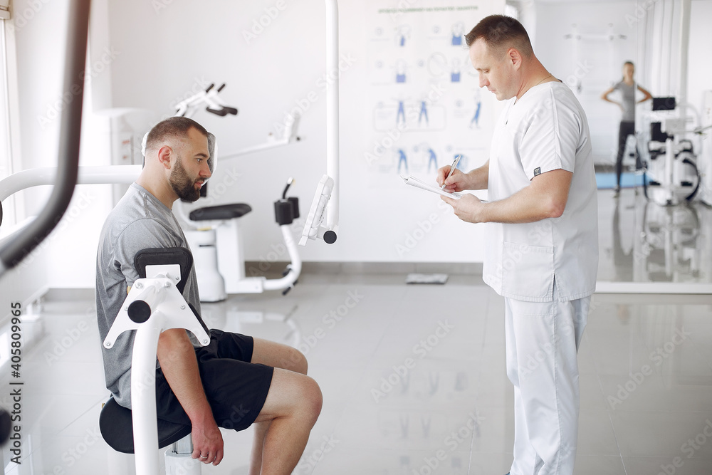Patient has a rehabilitation in physiotherapy clinic. Doctor in a uniform. Patient has a rehabilitation in physiotherapy clinic. Doctor in a uniform.