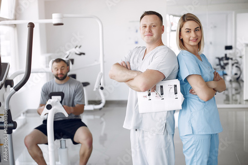 Patient has a rehabilitation in physiotherapy clinic. Doctor in a uniform.