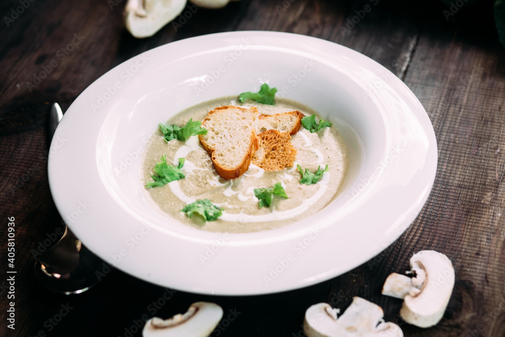 Mushroom cream soup on a white plate