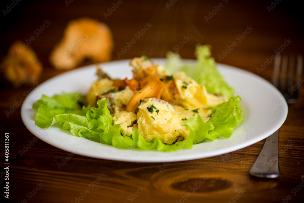 fried omelet with forest mushrooms chanterelles, on table fried omelet with forest mushrooms chanterelles, on table